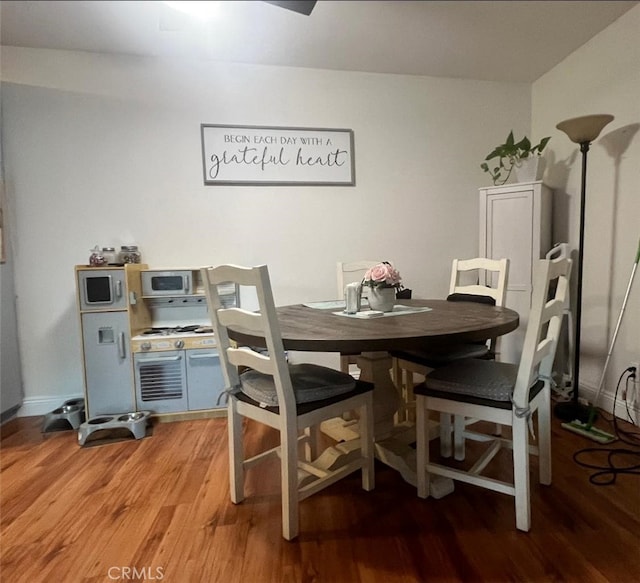 dining area with hardwood / wood-style floors