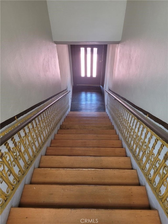 stairway with wood-type flooring