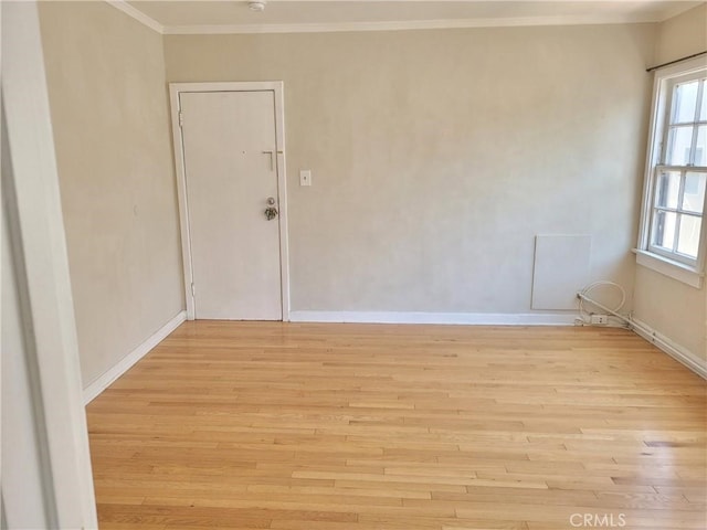 spare room featuring light hardwood / wood-style floors and ornamental molding