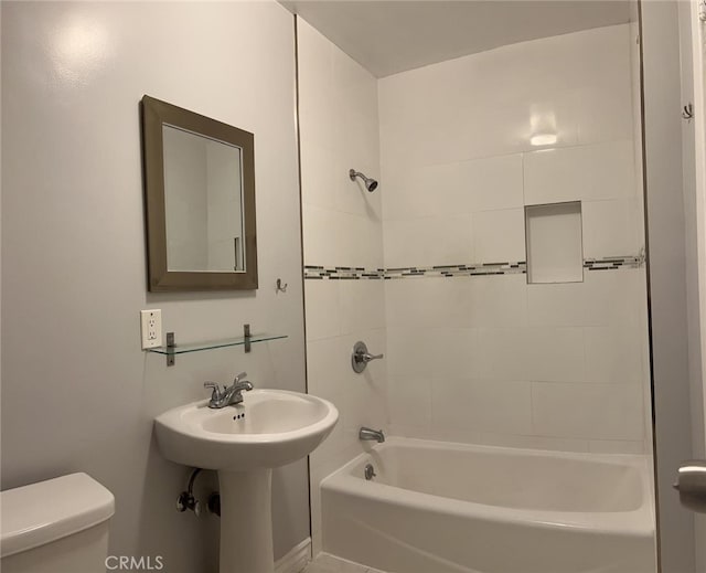 full bathroom featuring sink, toilet, and tiled shower / bath