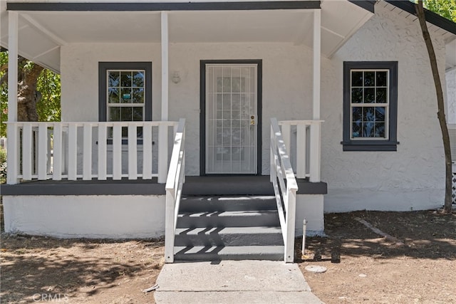 doorway to property with a porch