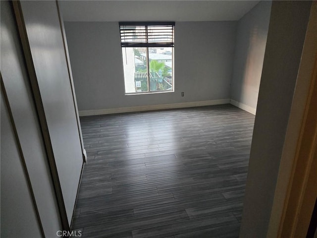 unfurnished room featuring dark hardwood / wood-style floors