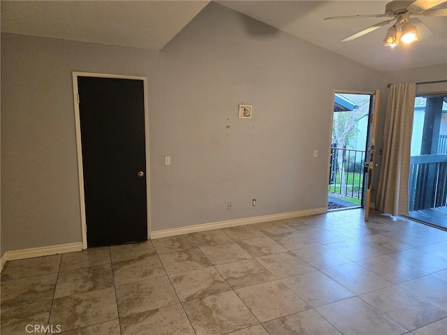 tiled spare room with ceiling fan and vaulted ceiling