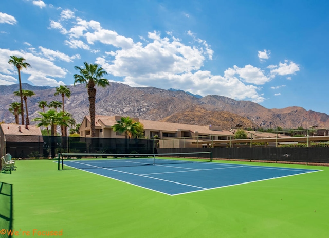 view of tennis court featuring a mountain view