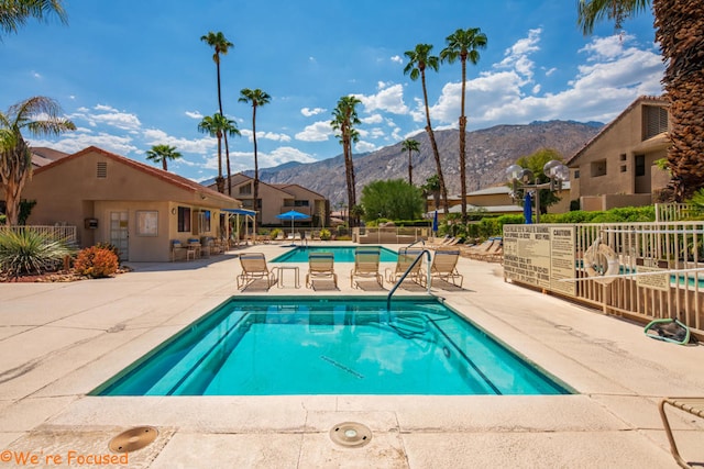 view of pool with a mountain view and a patio area