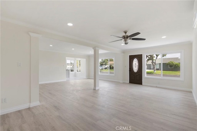 foyer featuring ceiling fan, ornamental molding, and a healthy amount of sunlight