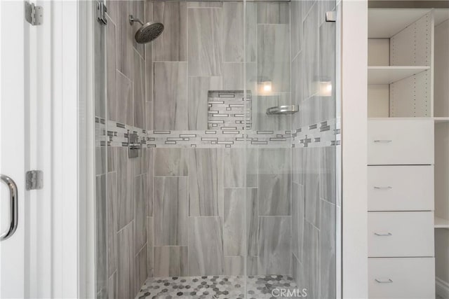 bathroom featuring a shower with shower door