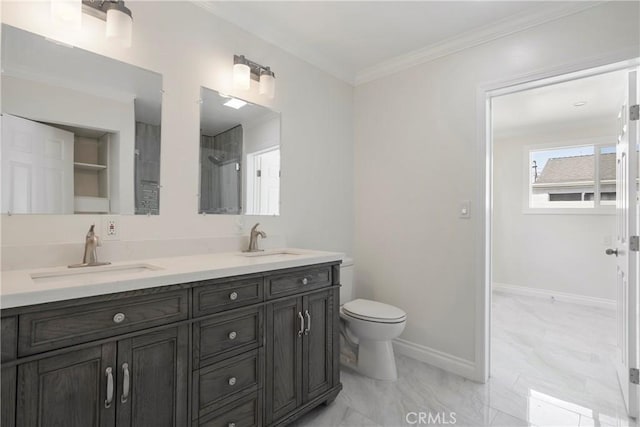 bathroom featuring toilet, vanity, and crown molding