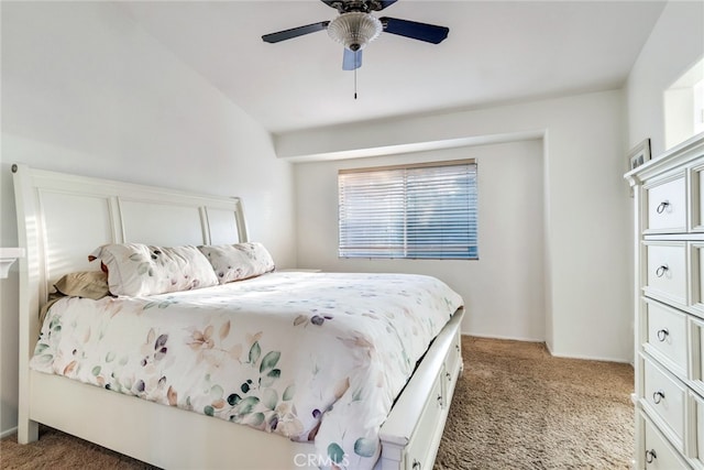 bedroom with lofted ceiling, dark colored carpet, and ceiling fan