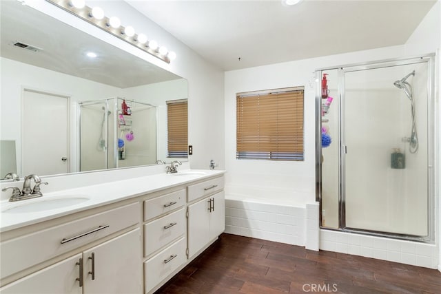 bathroom featuring vanity, shower with separate bathtub, and hardwood / wood-style floors