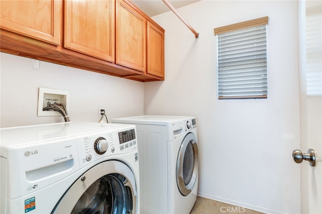 clothes washing area featuring cabinets, washing machine and clothes dryer, and a wealth of natural light