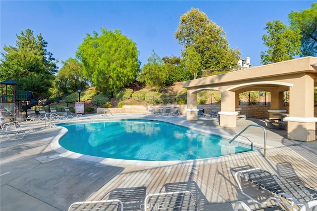 view of swimming pool with a patio area