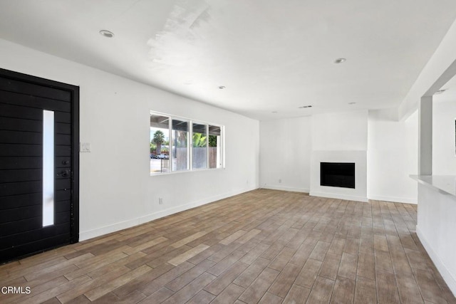 unfurnished living room featuring light wood-type flooring