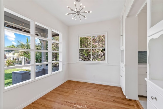 interior space featuring an inviting chandelier and light hardwood / wood-style floors