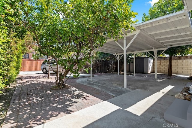 view of patio with a storage unit and a carport