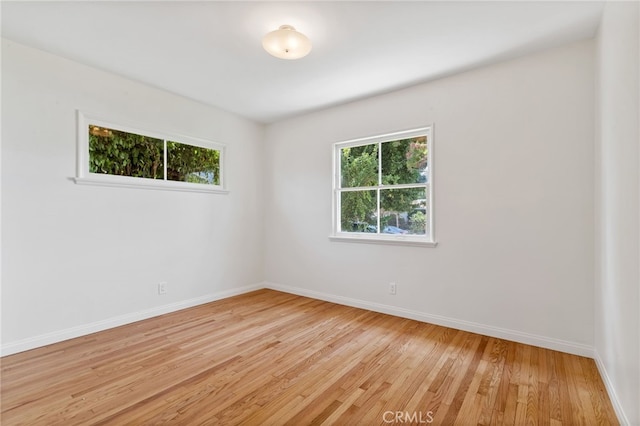 unfurnished room with light wood-type flooring