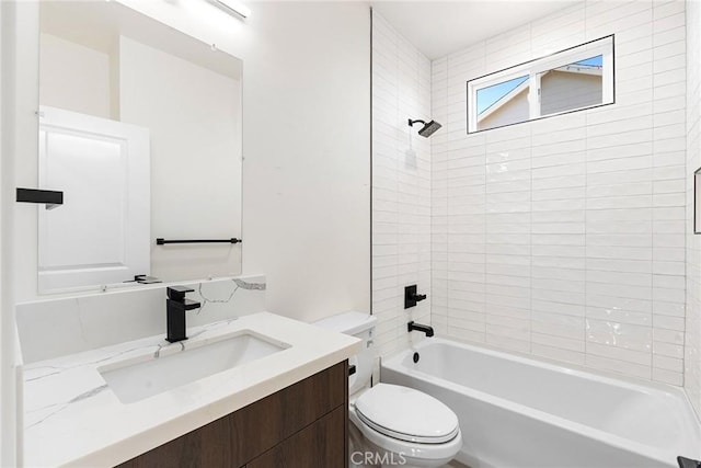 full bathroom featuring tiled shower / bath combo, toilet, and vanity