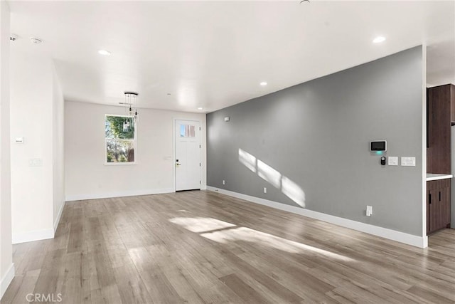 unfurnished living room with light hardwood / wood-style flooring