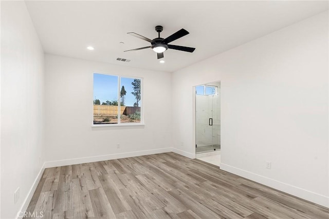 empty room with light hardwood / wood-style flooring and ceiling fan