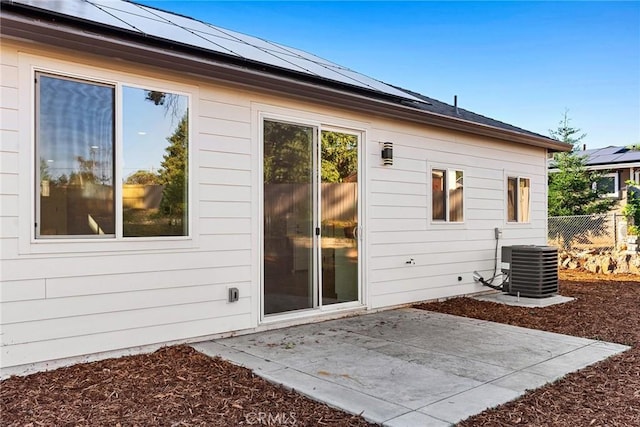 view of side of property with a patio and central AC unit