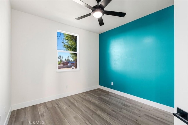 unfurnished room featuring hardwood / wood-style floors and ceiling fan