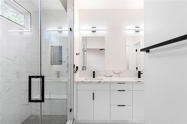 bathroom with vanity and a shower with door