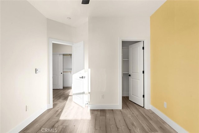 unfurnished bedroom with light wood-type flooring and a closet