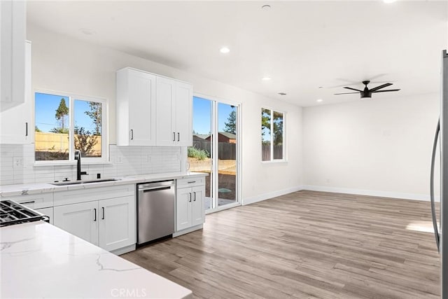 kitchen with dishwasher, sink, ceiling fan, light hardwood / wood-style floors, and white cabinetry