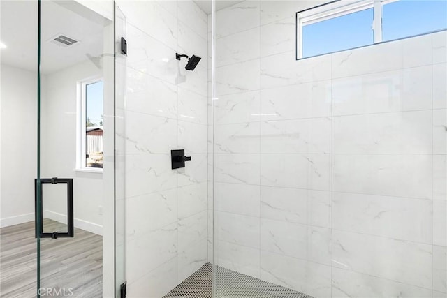 bathroom with walk in shower and hardwood / wood-style flooring