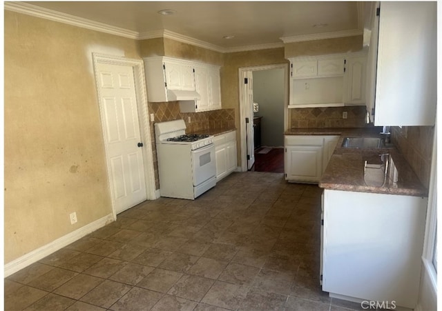 kitchen featuring backsplash, white cabinetry, white gas range oven, and sink