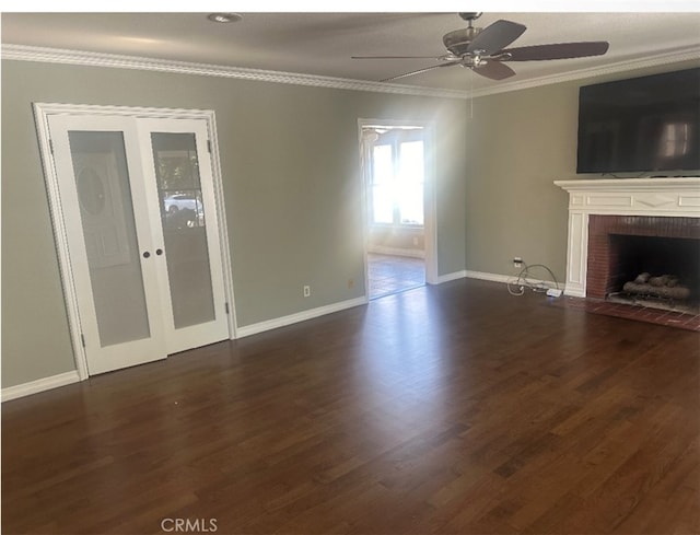 unfurnished living room with crown molding, dark wood-type flooring, ceiling fan, and a brick fireplace