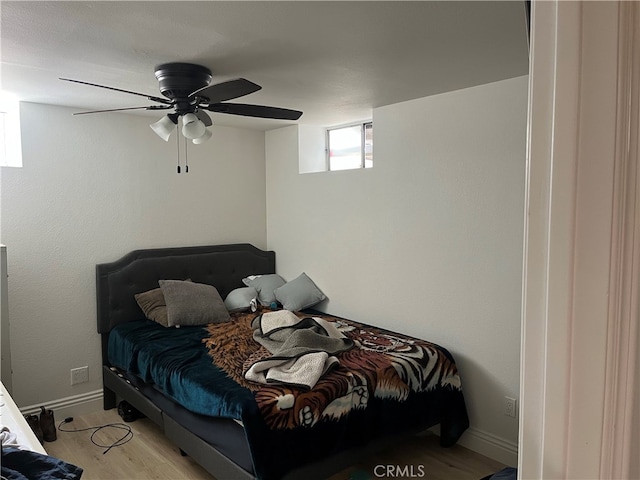 bedroom with ceiling fan and light wood-type flooring