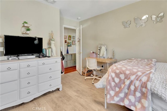 bedroom featuring visible vents and light wood-style flooring