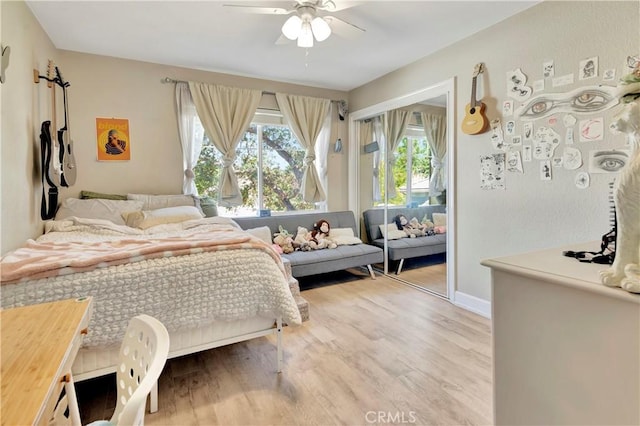 bedroom featuring access to outside, light wood-style flooring, baseboards, and ceiling fan