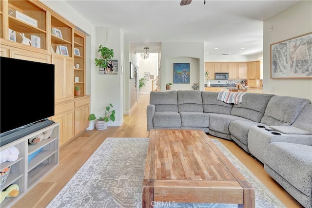 living room featuring recessed lighting, baseboards, light wood-style floors, and ceiling fan