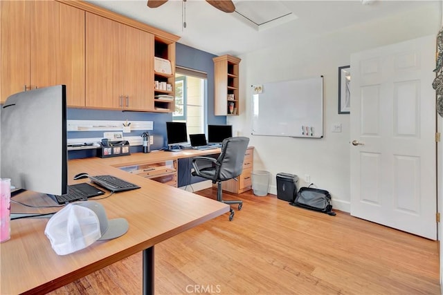 office area featuring baseboards, light wood-type flooring, and a ceiling fan