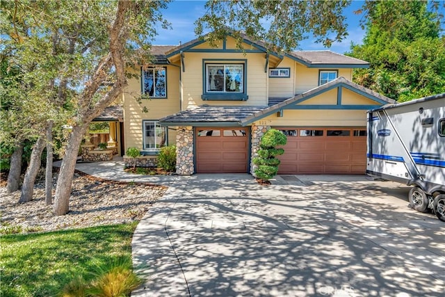 view of front of home with concrete driveway and stone siding