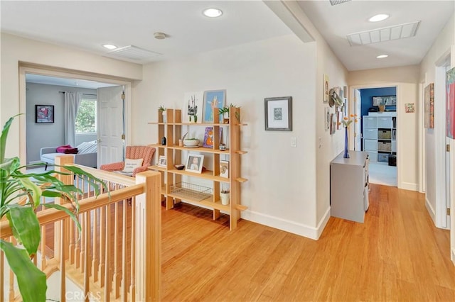 hallway featuring light wood-style flooring, recessed lighting, baseboards, and visible vents