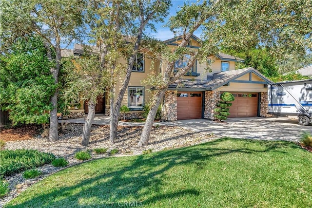 view of front of house featuring stone siding, stucco siding, driveway, and a front lawn