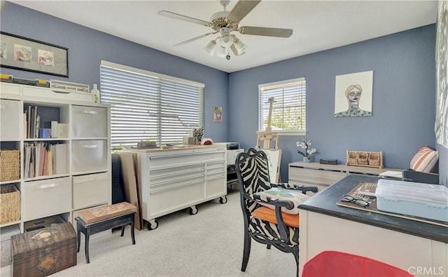 home office featuring ceiling fan and light carpet