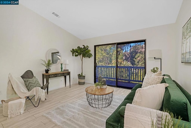 living area featuring light hardwood / wood-style flooring and lofted ceiling