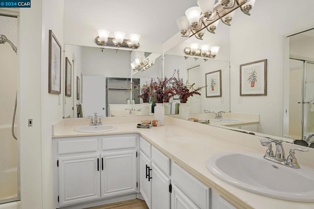 bathroom featuring hardwood / wood-style flooring, vanity, and an enclosed shower