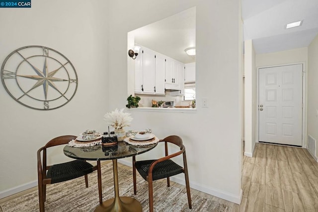 dining area with light wood-type flooring