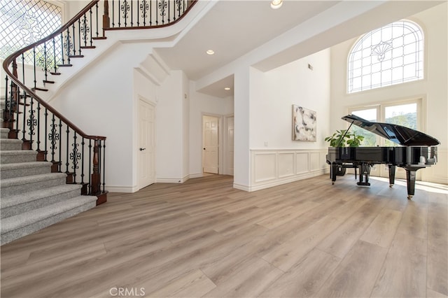 entrance foyer featuring light hardwood / wood-style flooring and a high ceiling