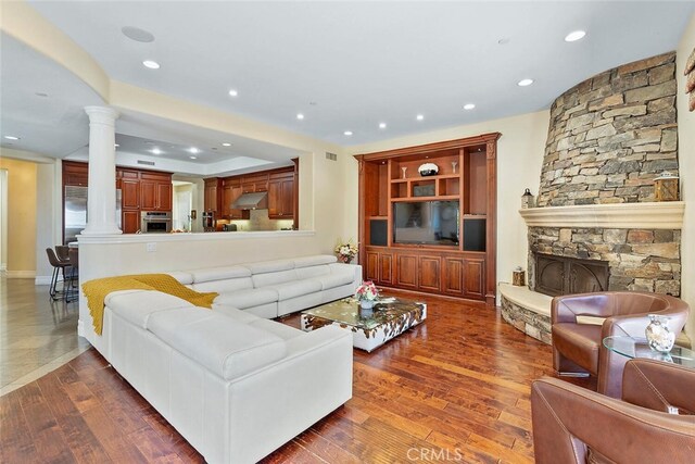 11755 Collar Ave, Tustin, CA 92782 - living room featuring decorative columns, wood finished floors, recessed lighting, and a fireplace