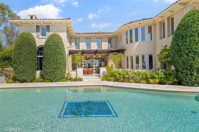 11755 Collar Ave, Tustin, CA 92782 - back of house featuring an outdoor pool, stucco siding, and a tiled roof
