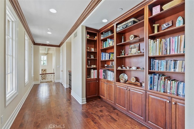 interior space featuring crown molding and dark wood-type flooring