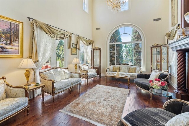11755 Collar Ave, Tustin, CA 92782 - living room featuring plenty of natural light, hardwood / wood-style flooring, a chandelier, and a high ceiling