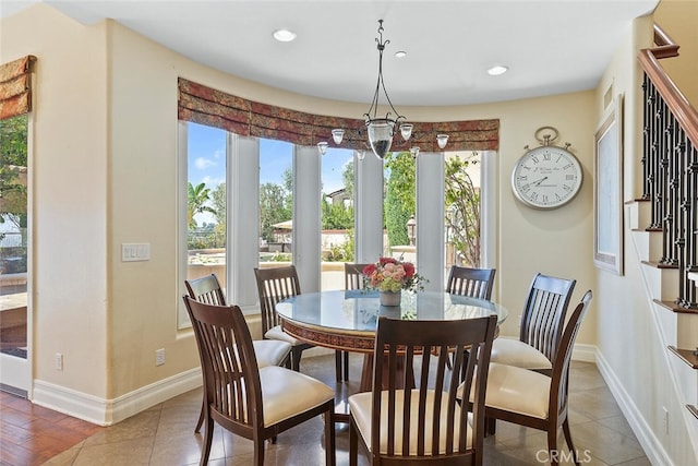 dining space featuring a notable chandelier and hardwood / wood-style flooring