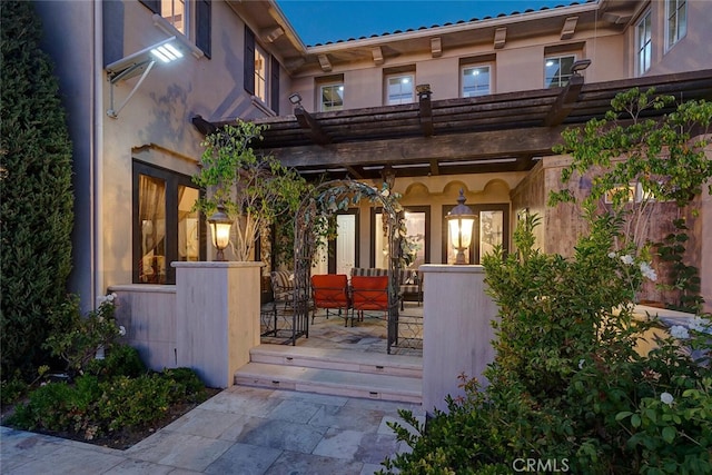 11755 Collar Ave, Tustin, CA 92782 - view of exterior entry with stucco siding and an outdoor living space